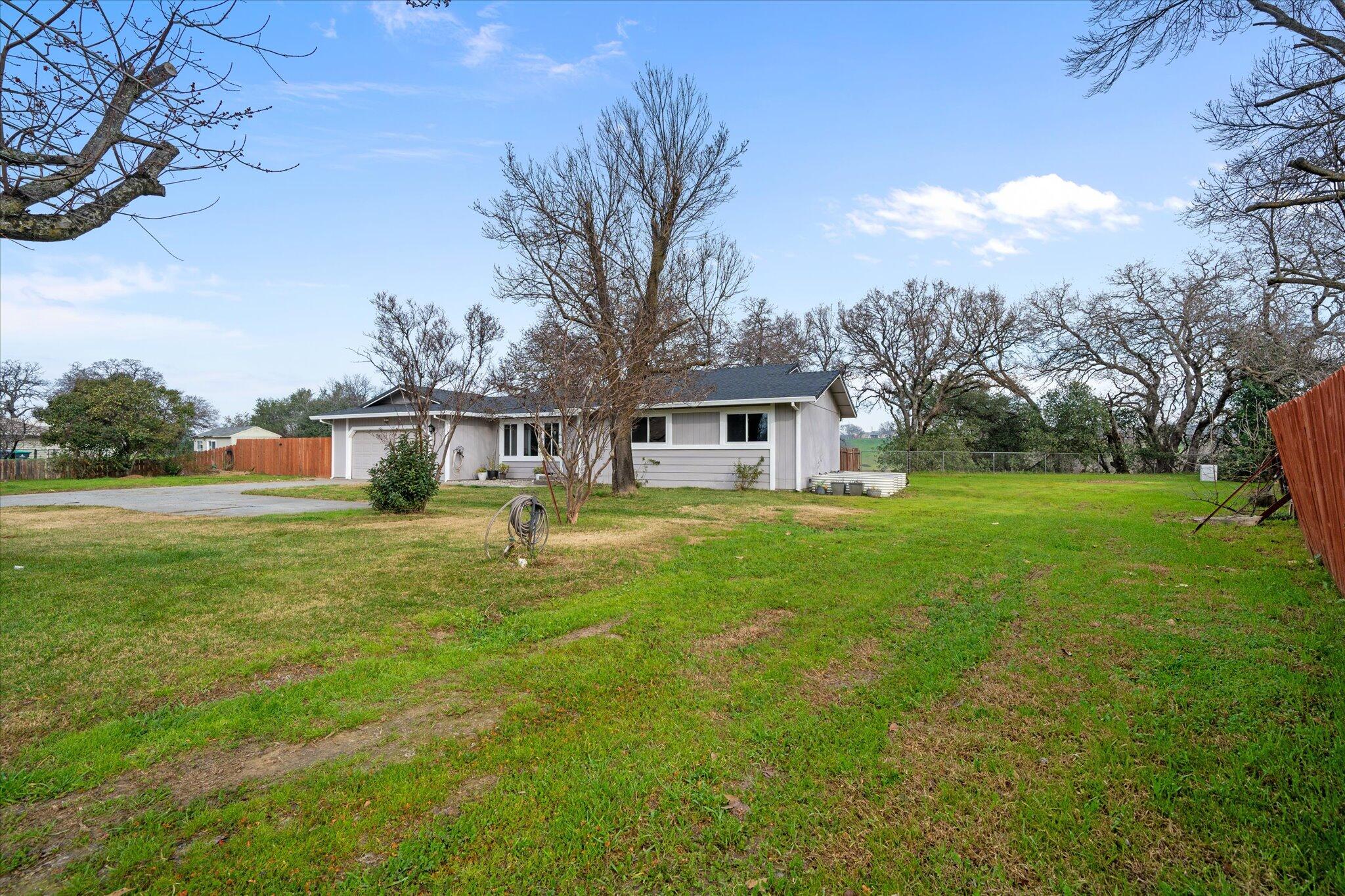 13770 Lisa Way Red Bluff, CA 96080 - Photo 5 of 43 a front view of house with yard and trees in the background