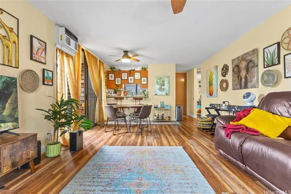 a living room with furniture or couch and a potted plant