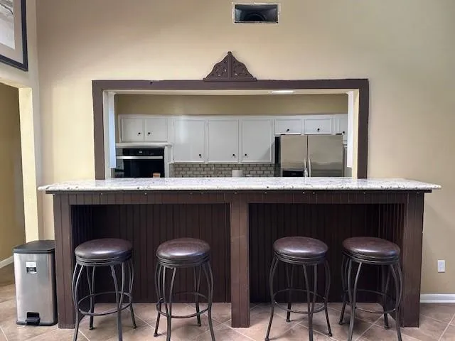 a kitchen with a dining table and chairs