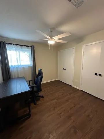 a workspace with furniture window and wooden floor