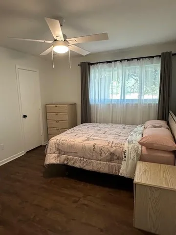 a bedroom with a large bed and a large window