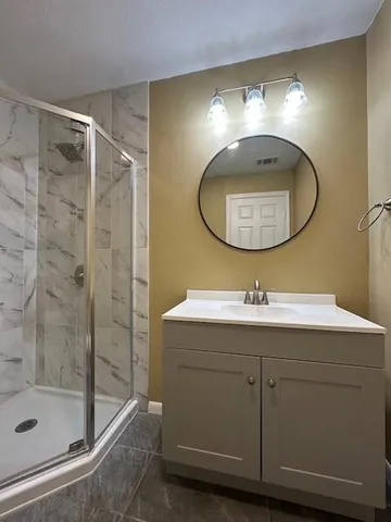 a bathroom with a mirror sink and vanity