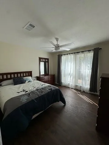 a spacious bedroom with a bed and a window