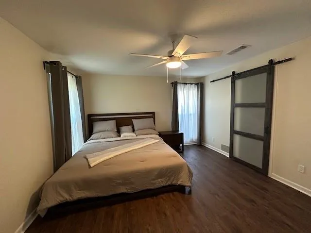 a bedroom with a bed and a chandelier