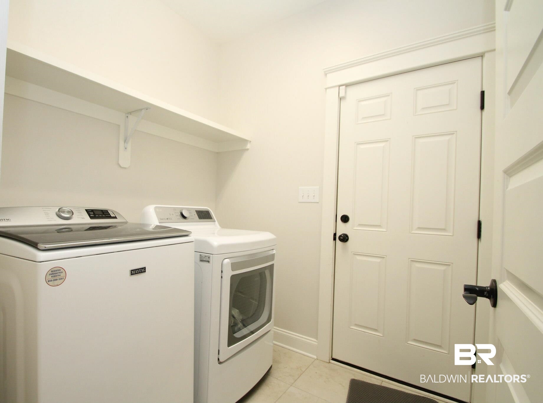 30232 Persimmon Drive Daphne, AL 36527 - Photo 20 of 27 Laundry area featuring washer and dryer, laundry area, baseboards, and light tile patterned floors