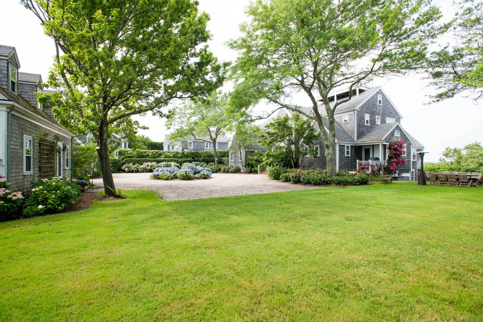 33 Cliff Road Nantucket, MA 02554 - Photo 17 of 84 a view of a white house that has a tree in front of it
