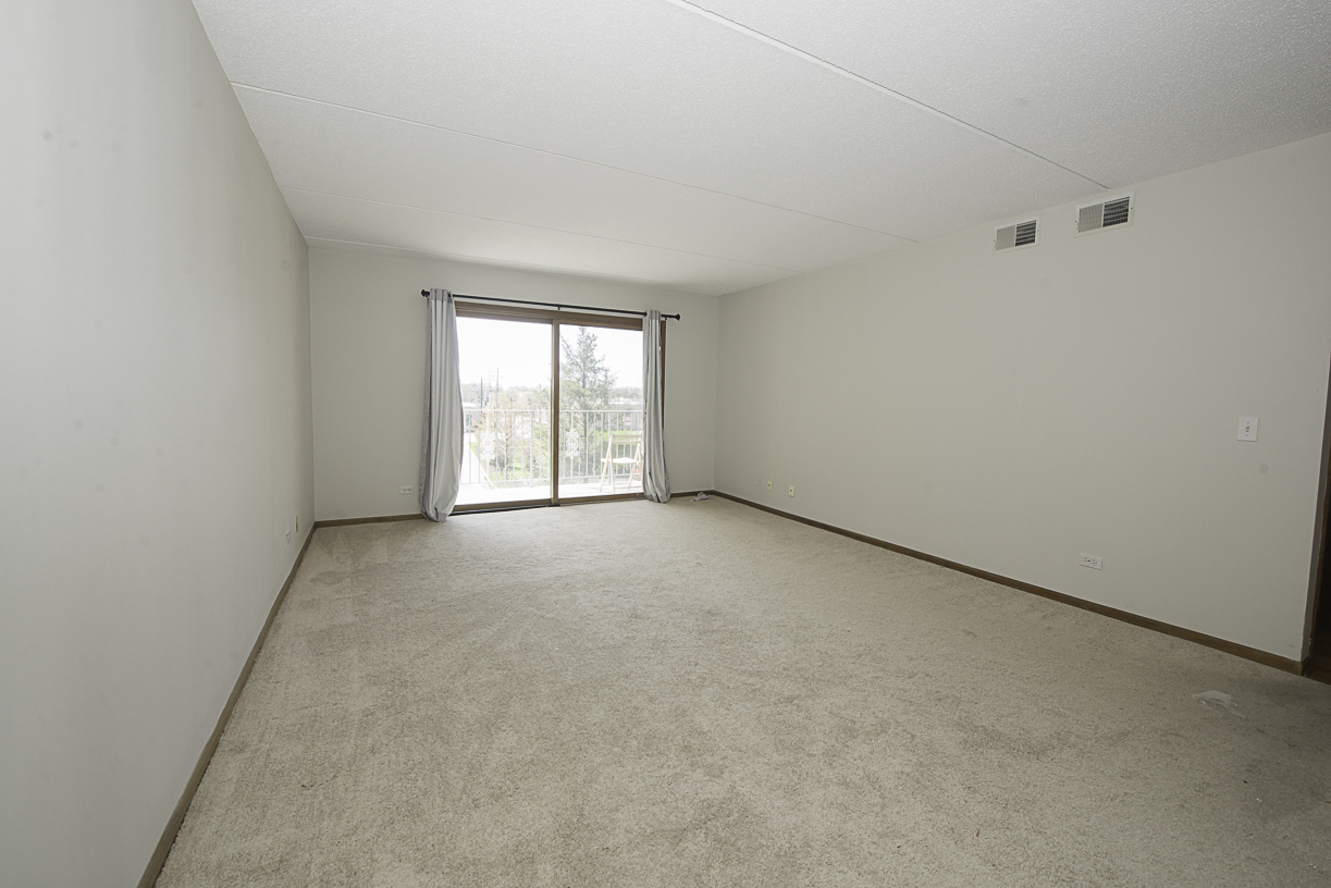 6540 West Irving Park Road, Unit 309 Chicago, IL 60634 - Photo 2 of 18 an empty room with windows