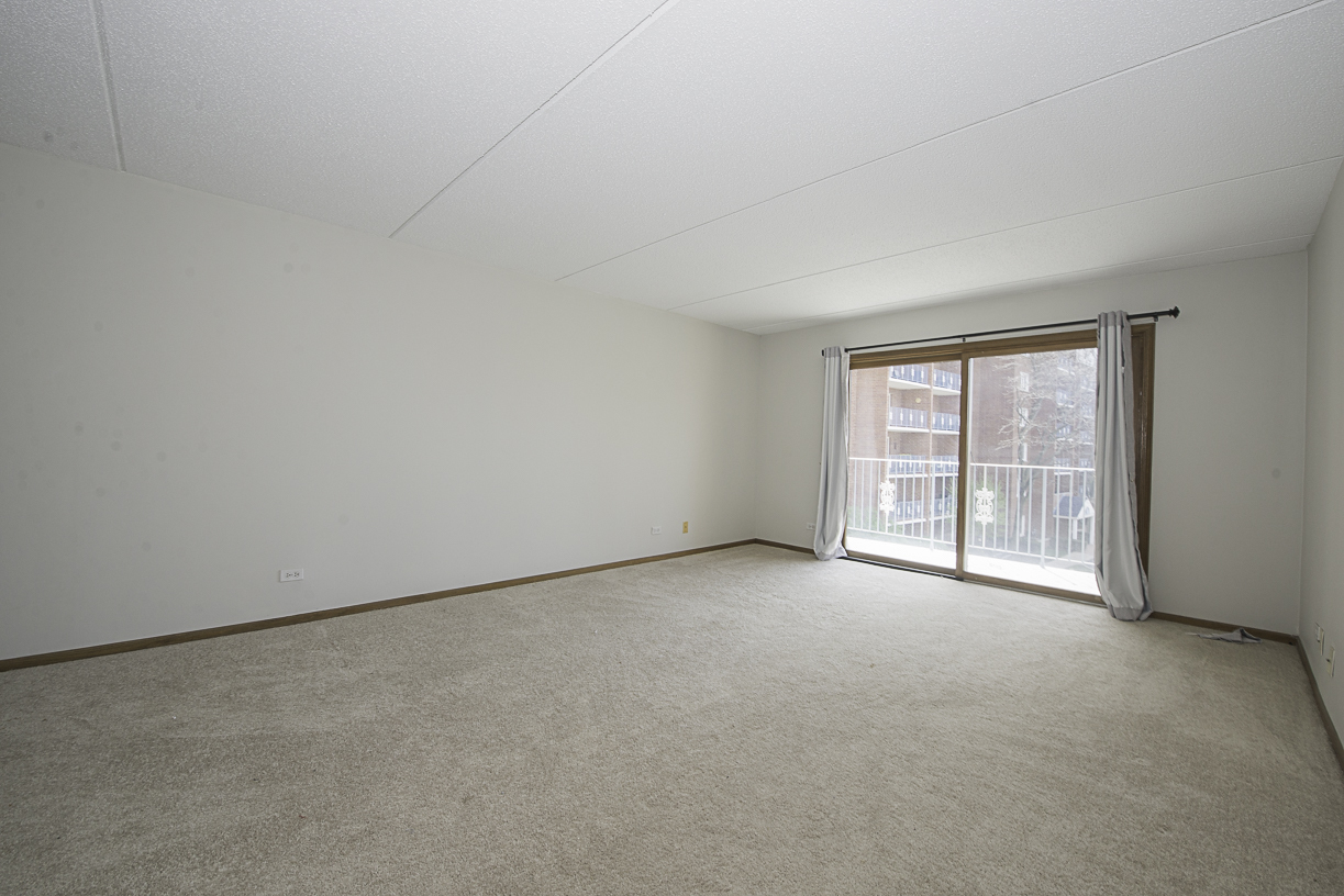 6540 West Irving Park Road, Unit 309 Chicago, IL 60634 - Photo 3 of 18 an empty room with windows