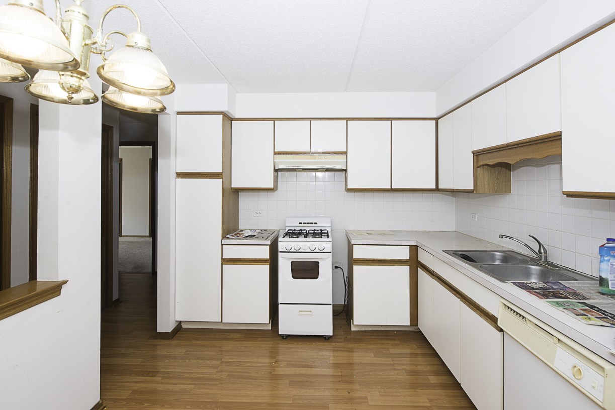 6540 West Irving Park Road, Unit 309 Chicago, IL 60634 - Photo 4 of 18 a kitchen with stainless steel appliances granite countertop a sink a stove and a refrigerator