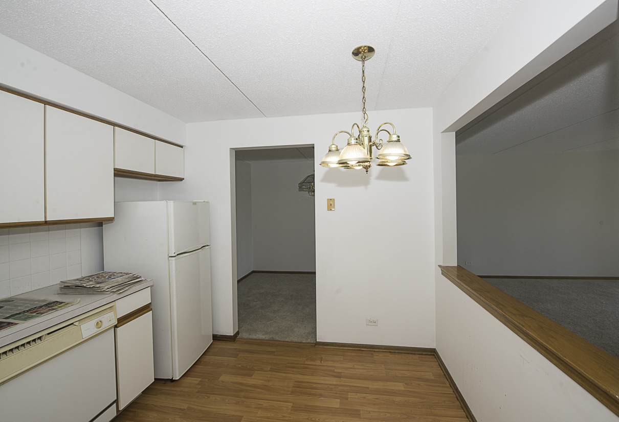 6540 West Irving Park Road, Unit 309 Chicago, IL 60634 - Photo 7 of 18 a view of an empty room with window and wooden floor