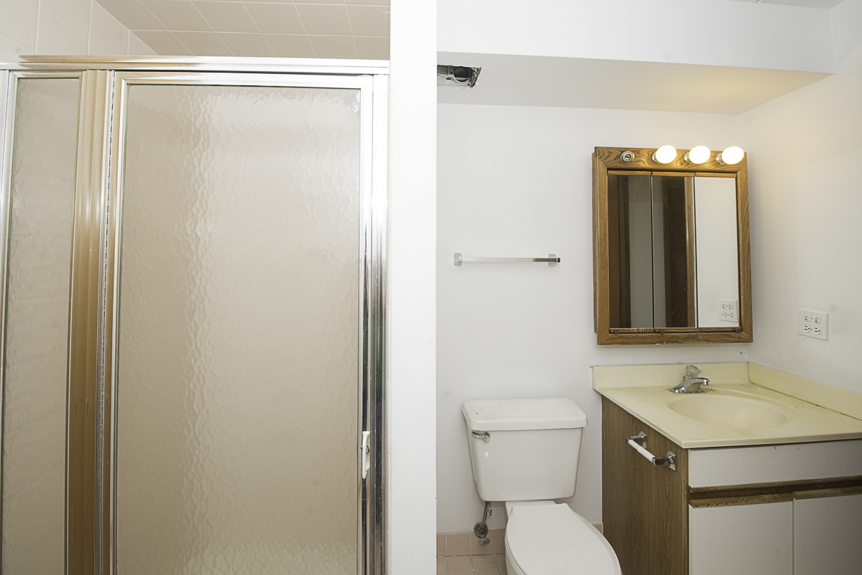6540 West Irving Park Road, Unit 309 Chicago, IL 60634 - Photo 10 of 18 a bathroom with a sink a toilet and shower