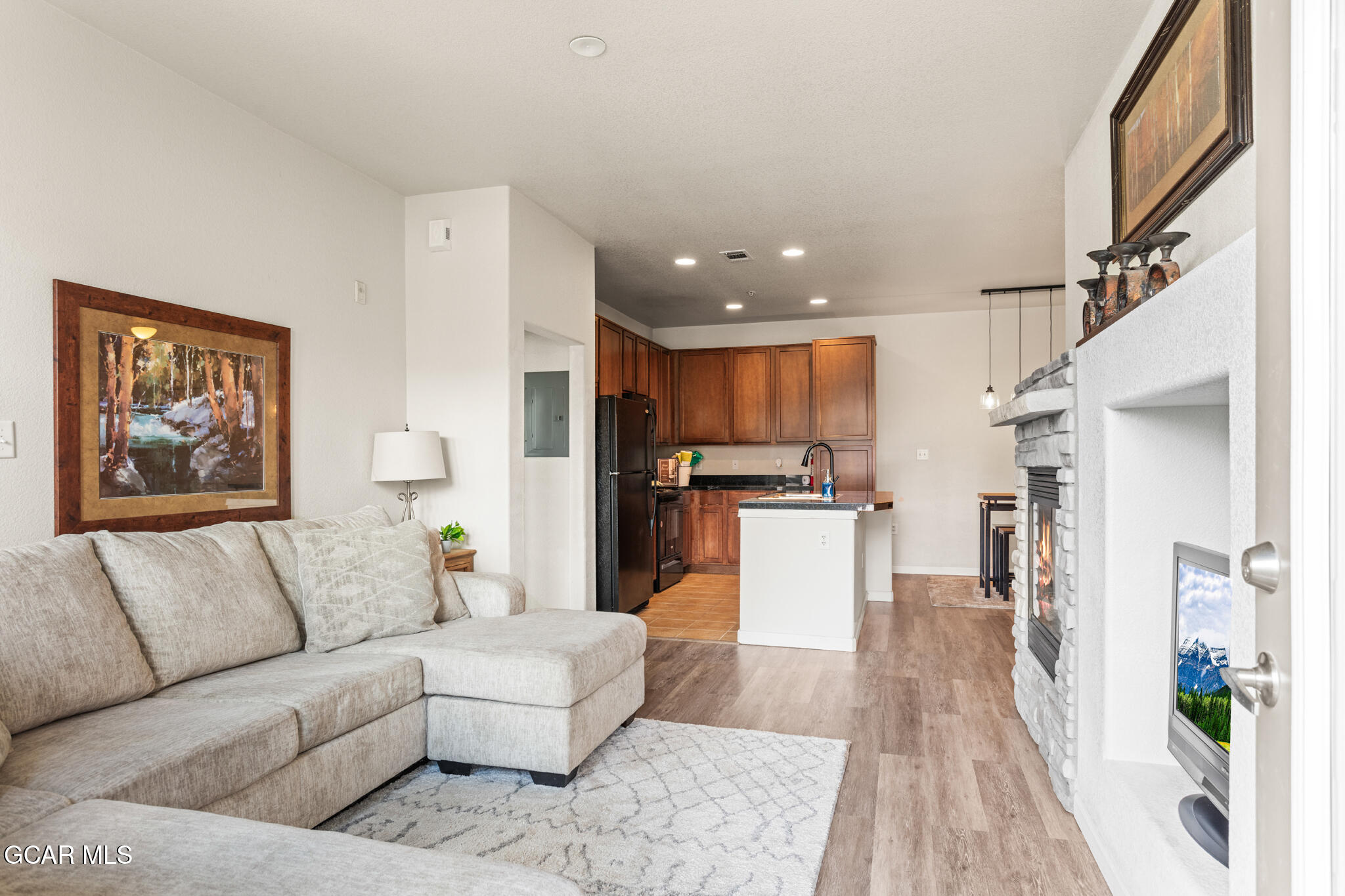 a living room with furniture and a kitchen view