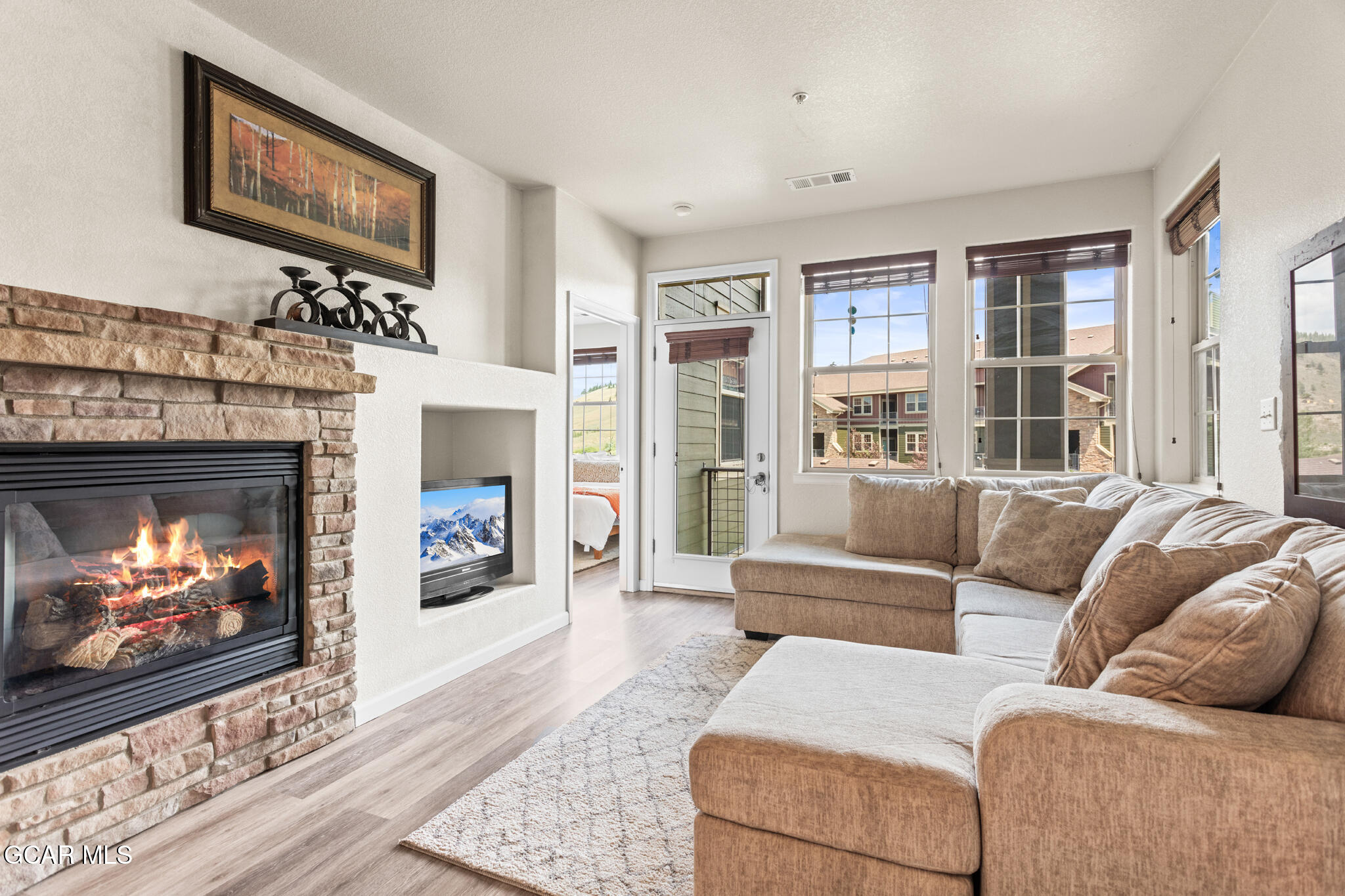 152 Village Road, Unit B206 Granby, CO 80446 - Photo 2 of 30 a living room with furniture a flat screen tv and a fireplace