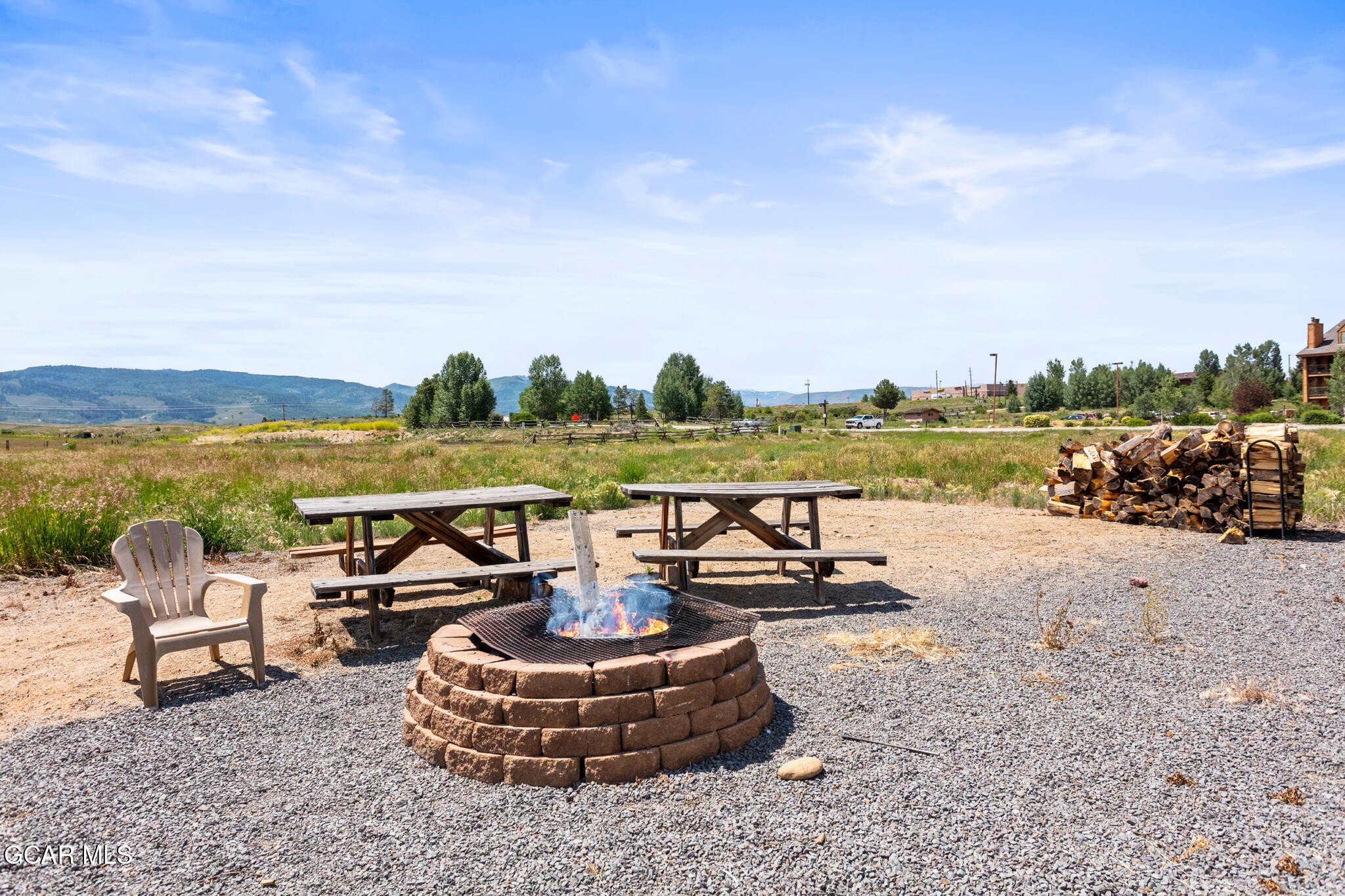 152 Village Road, Unit B206 Granby, CO 80446 - Photo 22 of 30 a view of a lake with couches chairs and a table
