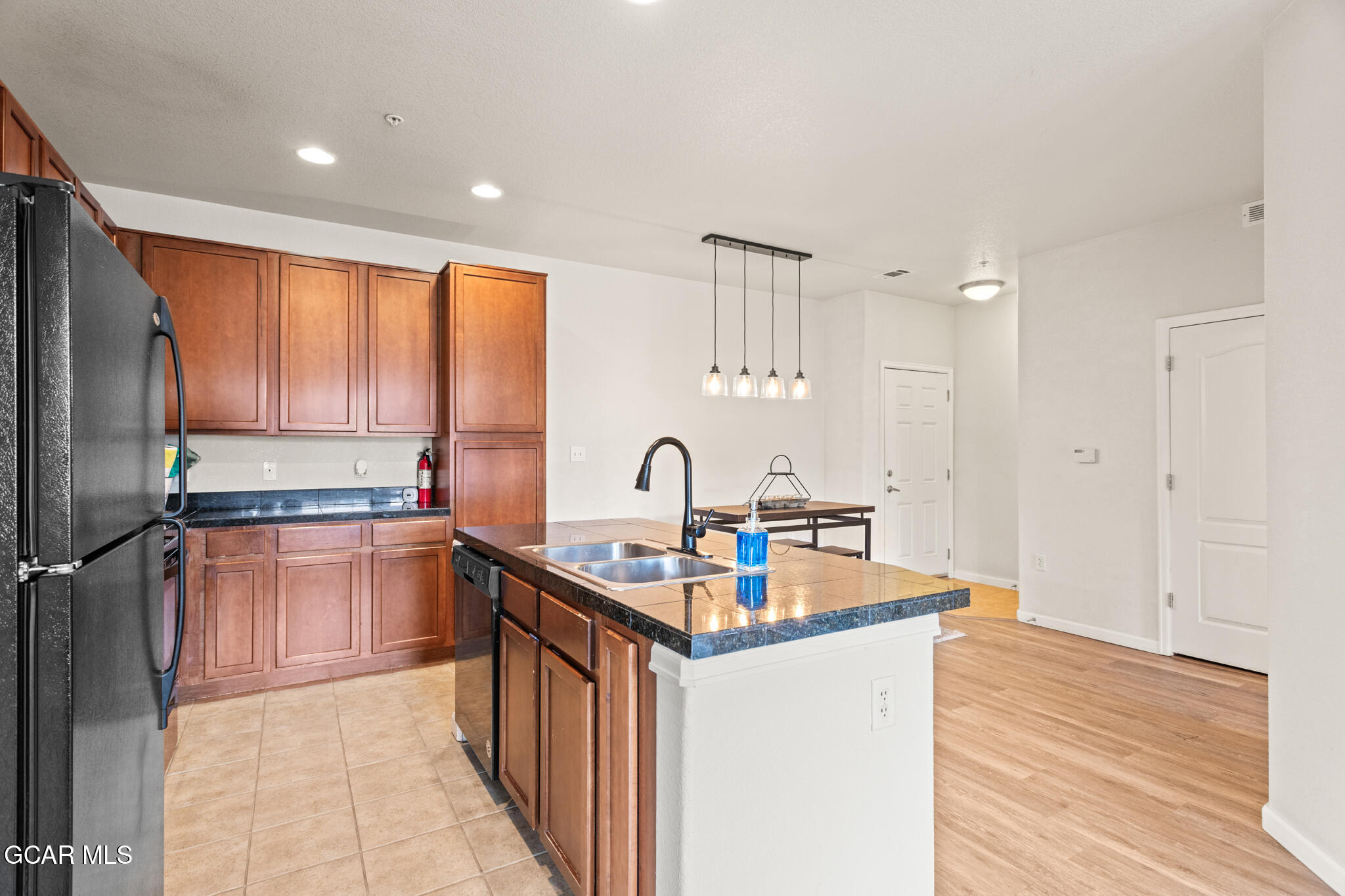 152 Village Road, Unit B206 Granby, CO 80446 - Photo 5 of 30 a kitchen with stainless steel appliances granite countertop a sink stove and refrigerator