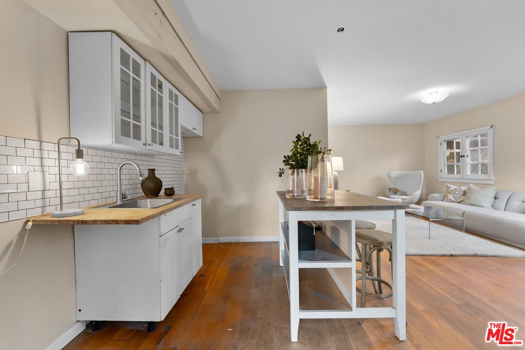 2107 Santa Rosa Avenue Altadena, CA 91001 - Photo 22 of 25 a kitchen with granite countertop a sink and chairs