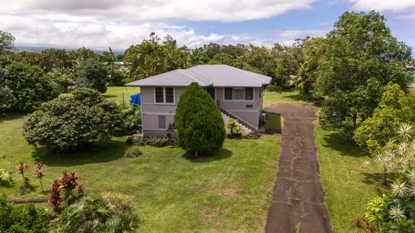 a view of a garden with a house