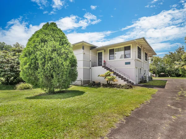 a view of a house with a yard