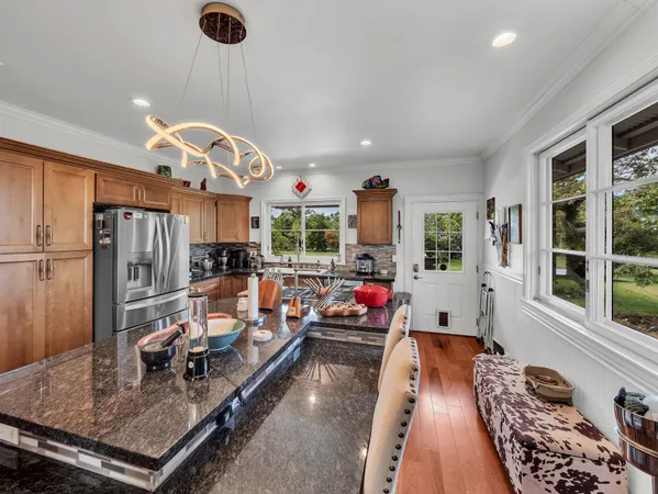 a very nice looking living room with a large window and stainless steel appliances