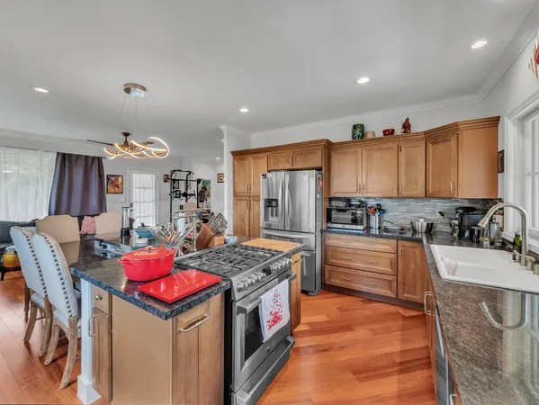 a kitchen with a stove a refrigerator and a dining table