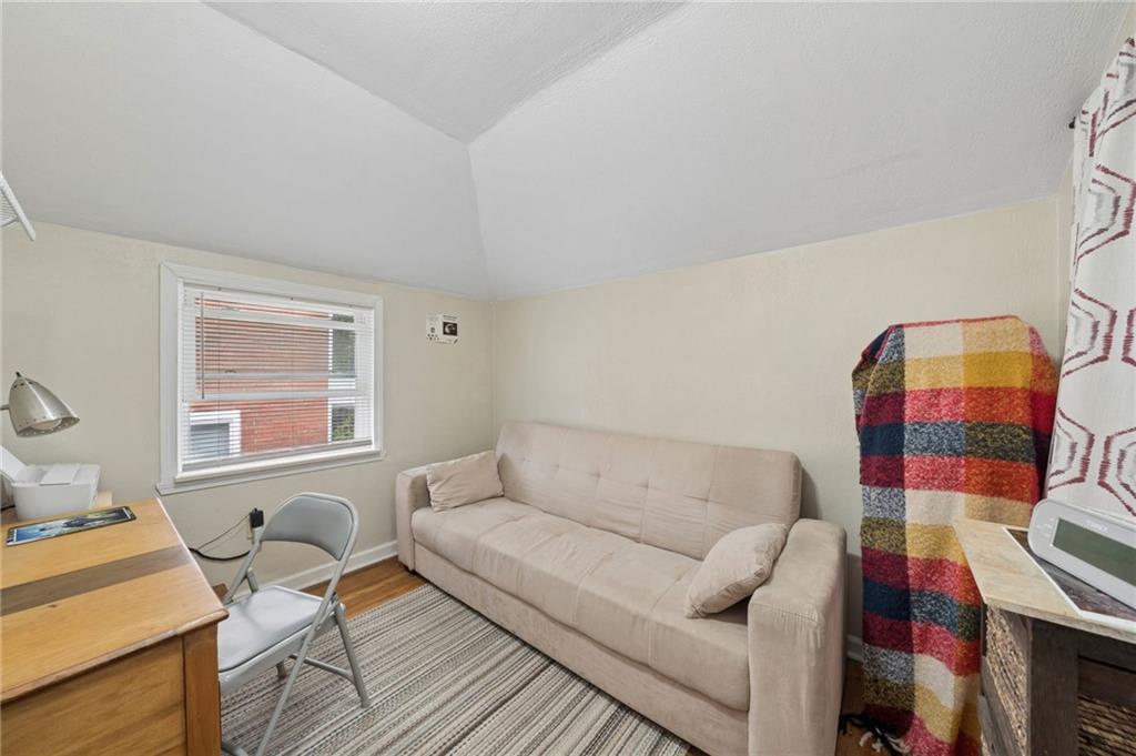 2106 Lindsay Road Pittsburgh, PA 15221 - Photo 23 of 36 This third bedroom features a compact layout with hardwood floors, and a single double-hung window overlooking the yard.