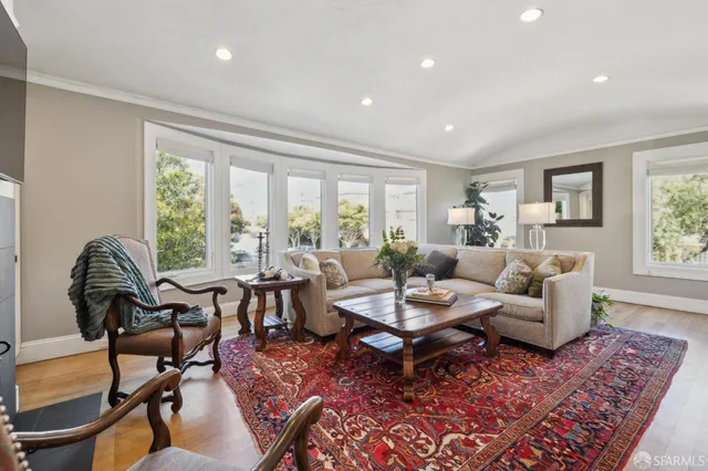 a view of a kitchen area with furniture and wooden floor