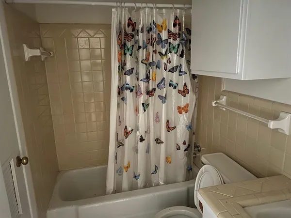 a bathroom with a toilet and shower