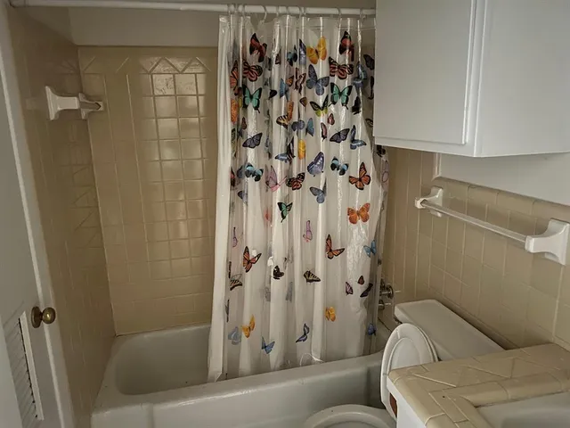 a bathroom with a toilet and shower