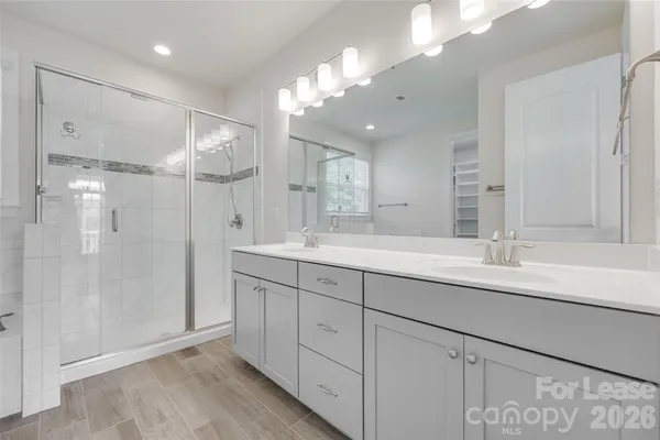 a bathroom with a double vanity sink and a mirror
