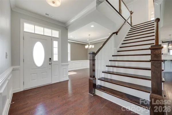a view of a hallway with entryway wooden floor and front door