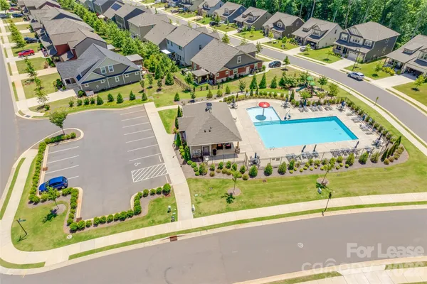 an aerial view of a house with a big yard and large trees