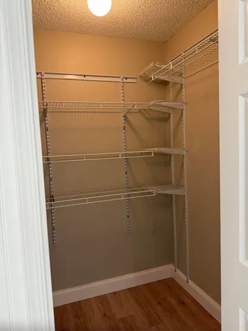 a view of a room with wooden floor