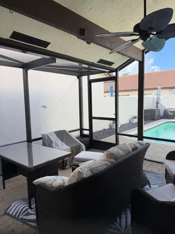 a living room with furniture and a floor to ceiling window