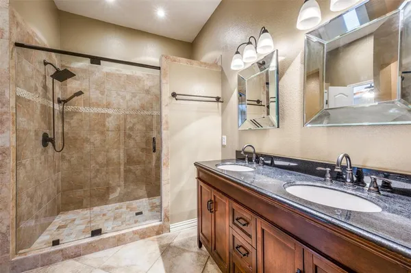 a bathroom with a sink double vanity and a shower