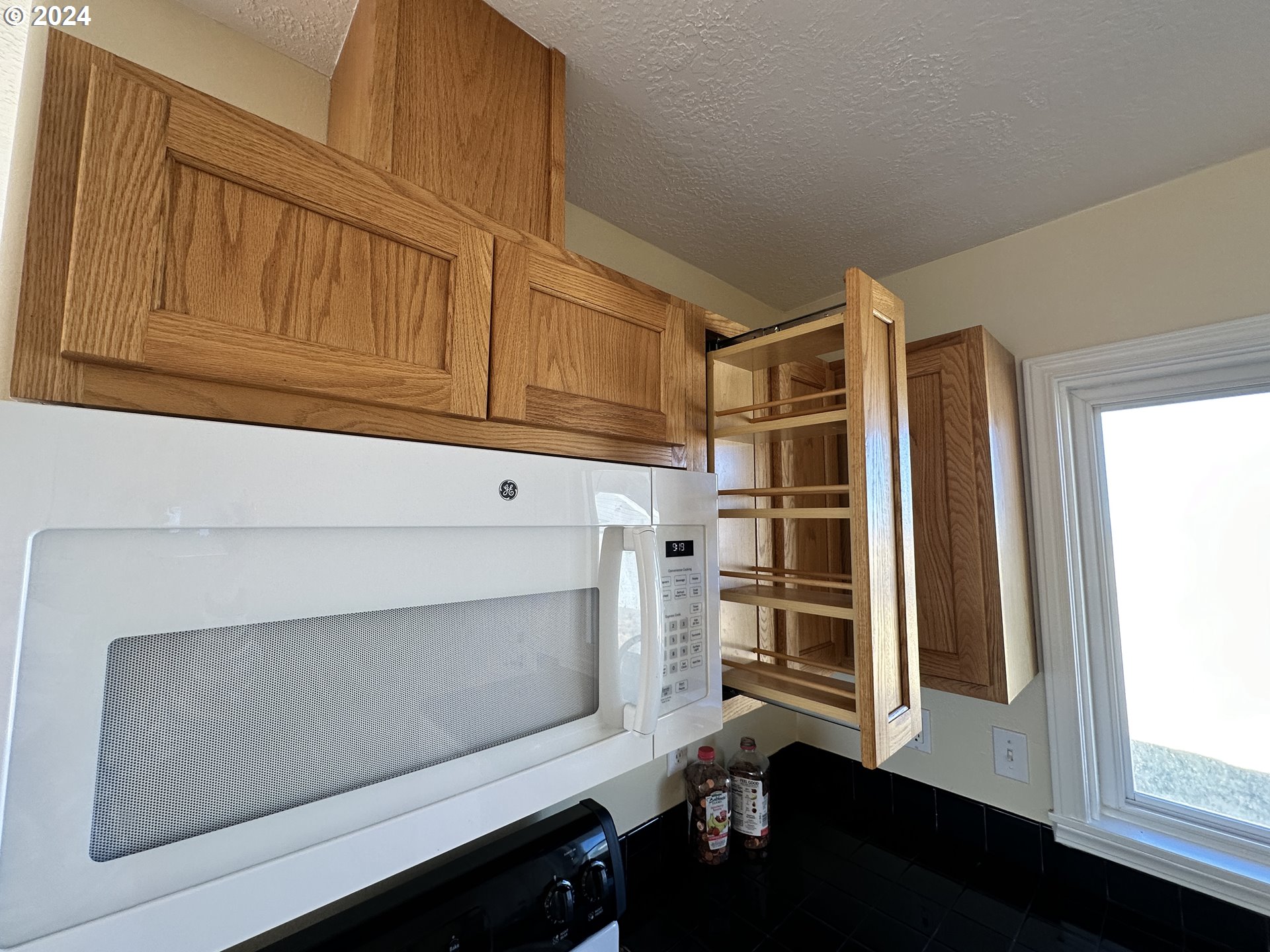 14865 Mount View Drive Condon, OR 97823 - Photo 19 of 23 a kitchen with white cabinets and black appliances