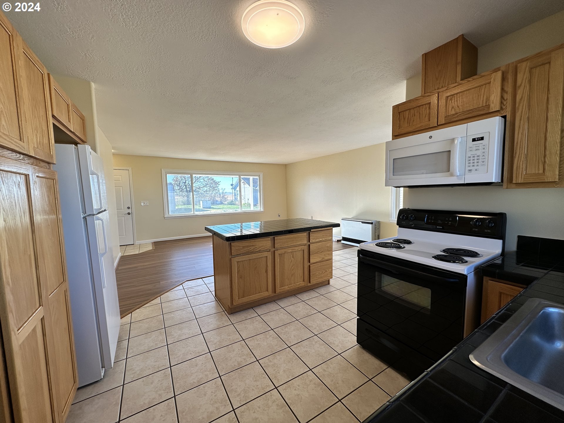 14865 Mount View Drive Condon, OR 97823 - Photo 10 of 23 a kitchen with stainless steel appliances granite countertop a stove a sink and a refrigerator