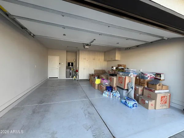 a view of a backyard with a table and chairs under an umbrella