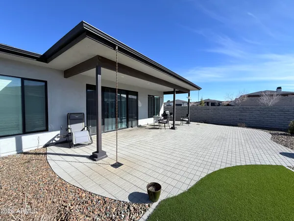 a spacious bathroom with a double vanity sink a mirror and a shower