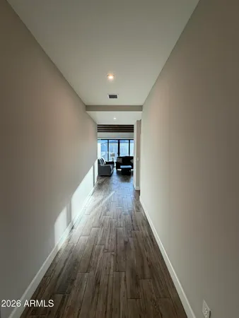 a view of a room with wooden floor and furniture