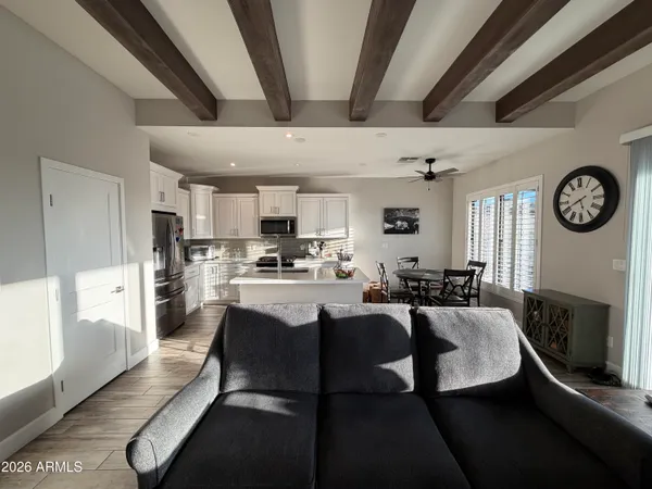 a large kitchen with a table chairs stove and refrigerator