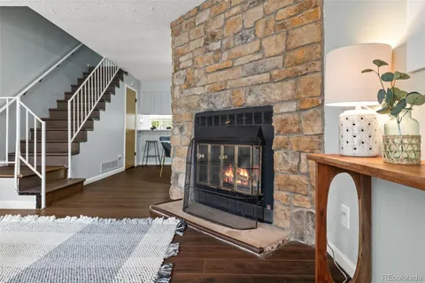 a living room with fireplace furniture and a wooden floor