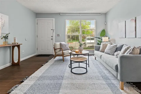 a living room with furniture a window and a table