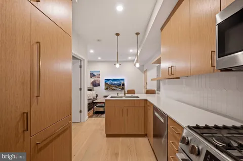 a kitchen with cabinets and a stove