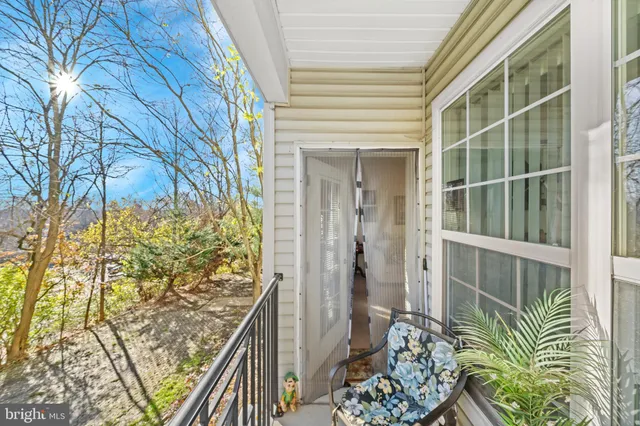 a bedroom with furniture and a large window
