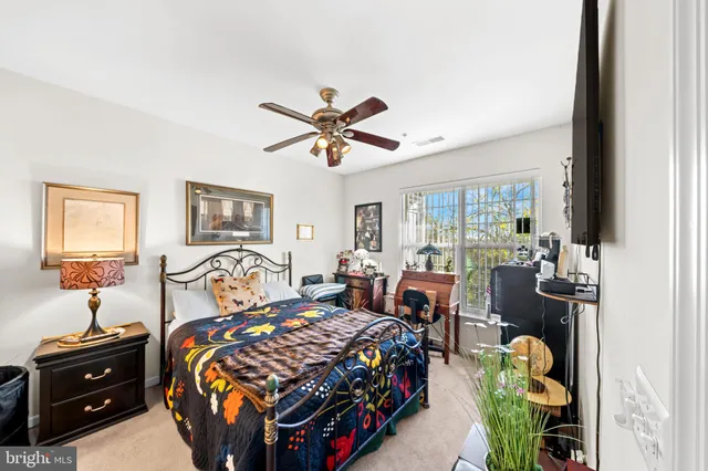 a bedroom with bed and a chandelier