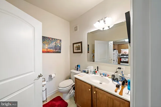 a en suite bathroom with a double vanity sink a mirror and shower