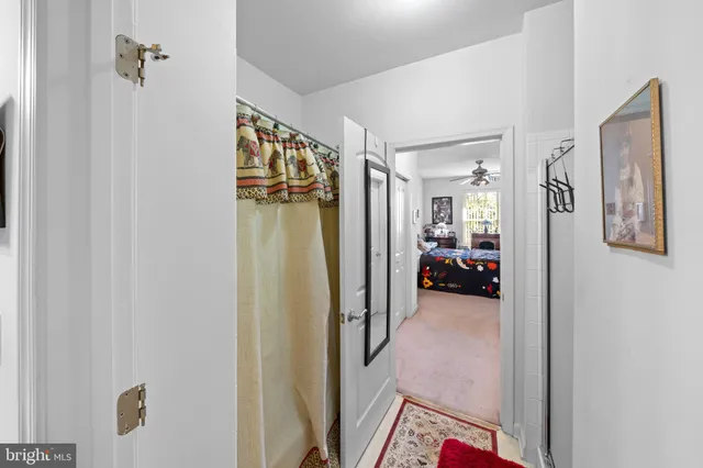 a bathroom with a bath tub sink mirror vanity and toilet