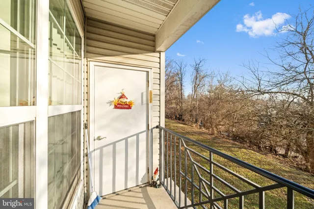 a view of a house with a big yard and large trees