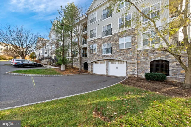 a view of a house with a big yard and large trees