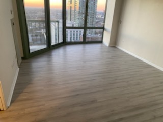 111 West Maple Street, Unit 2309 Chicago, IL 60610 - Photo 4 of 11 a view of an empty room with wooden floor and a window